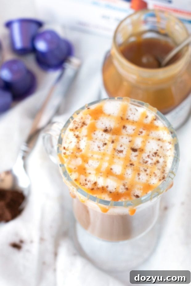 Chili Caramel Macchiato in a clear mug, showcasing the layers of espresso and frothed almond milk