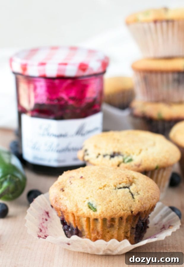 Close-up of a single Blueberry Jalapeño Bacon Cornbread Muffin, highlighting its texture and a hint of blueberry swirl