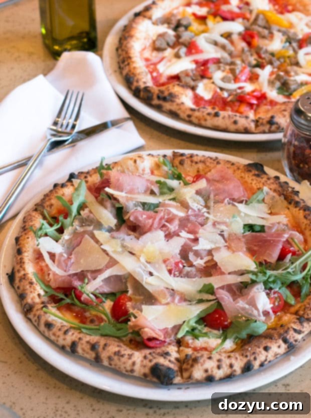 Delicious Toscana pizza with fresh arugula, prosciutto, and sheep's milk cheese at Racca's Pizzeria