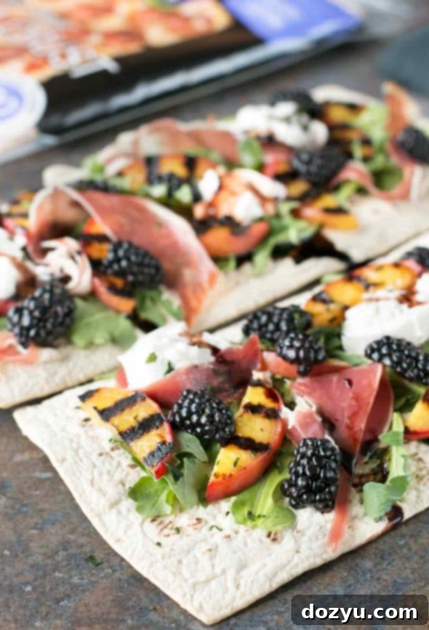 Assembled grilled peach prosciutto flatbread with burrata and fresh ingredients