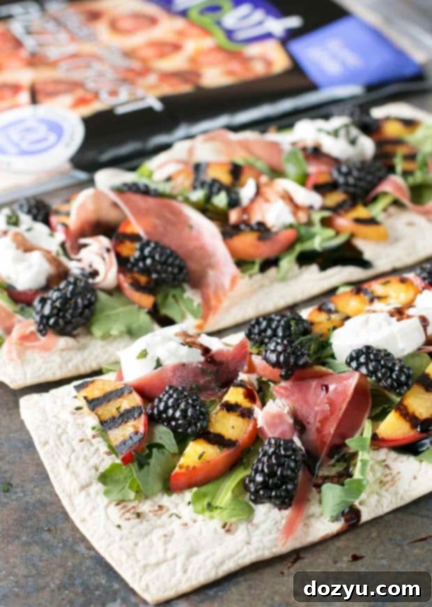 Close-up of a single slice of grilled peach prosciutto flatbread