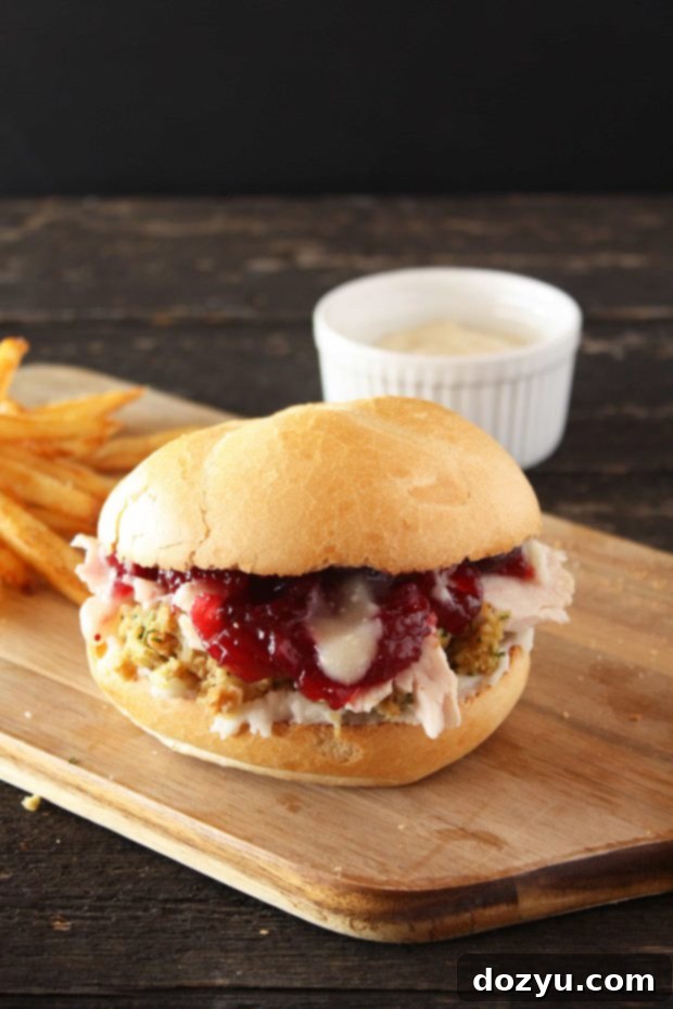 The Ultimate Thanksgiving Leftovers Sandwich on a plate with golden fries.