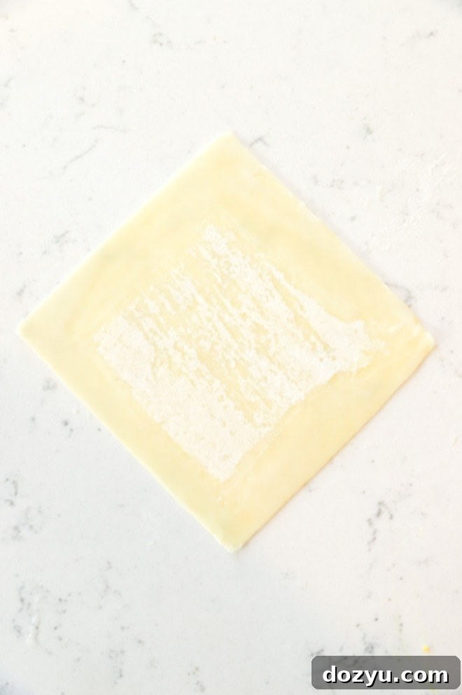 Avocado Jalapeño Popper Wonton Bites 6 A single wonton wrapper laid flat on a clean work surface, shaped like a diamond