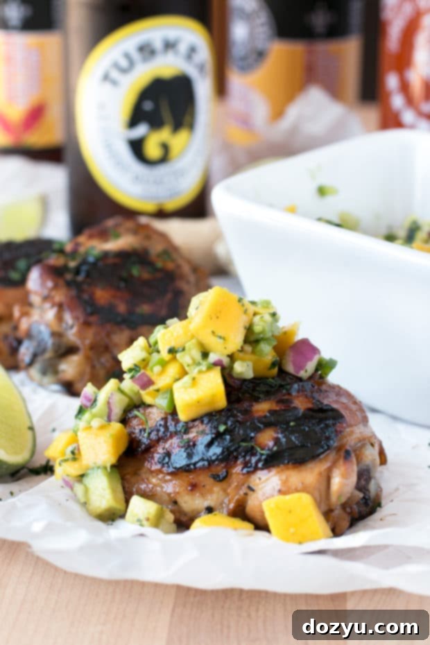 Zesty Ginger-Grilled Chicken Thighs with Creamy Avocado Salsa 2 Perfectly grilled spicy ginger chicken thighs with fresh avocado salsa, ready to be enjoyed. A delicious summer recipe for grilling enthusiasts.