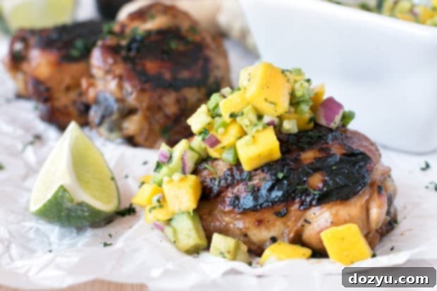 Zesty Ginger-Grilled Chicken Thighs with Creamy Avocado Salsa 5 Exquisitely plated spicy ginger grilled chicken thighs with a generous serving of avocado salsa and fresh lime wedges. A gourmet yet simple meal.