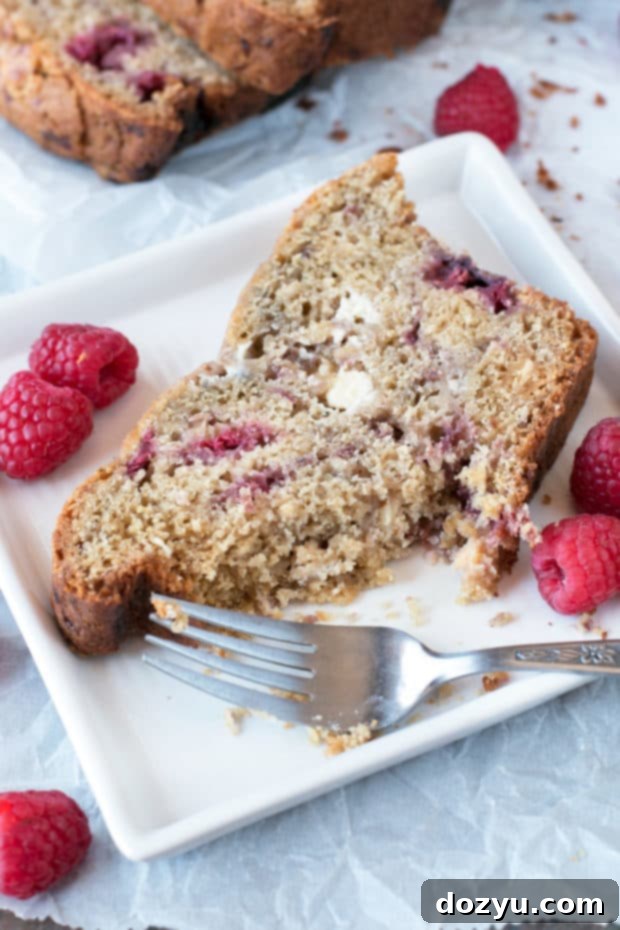 Close-up of the Raspberry Lemon White Chocolate Chip Loaf showing the perfectly baked crust and vibrant fruit.