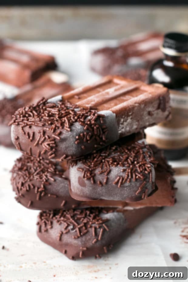 Dark Chocolate Dipped Mocha Popsicles garnished with chocolate sprinkles.