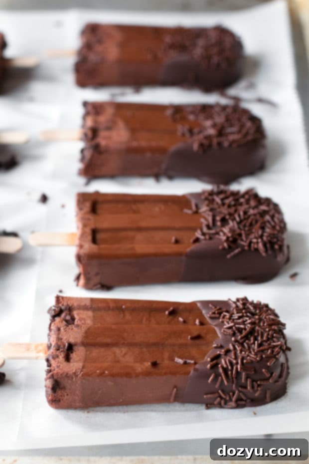 Delicious Dark Chocolate Dipped Mocha Popsicles cooling down a hot summer day.