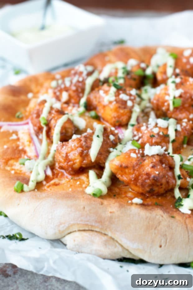 Buffalo Chicken Pizza with Blue Cheese Avocado Dressing | cakenknife.com #pizza #buffalochicken #chickenwings