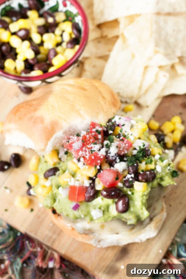 Fresh ingredients laid out for Southwestern Guacamole Burgers, including ripe avocados, onions, jalapeños, and perfectly formed raw burger patties.