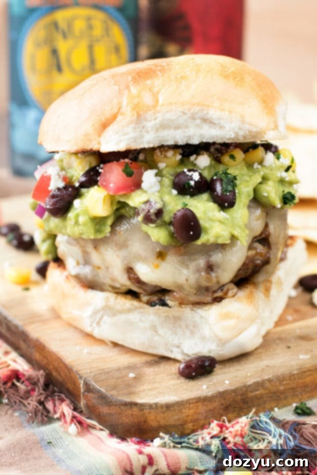 A collection of fresh ingredients for a Southwestern Guacamole Burger, including ground meat, various spices, and colorful vegetables.