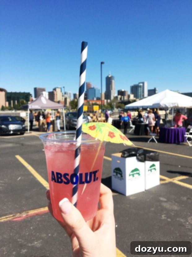 A person holding a glass of exquisite wine at the Denver Food + Wine Festival