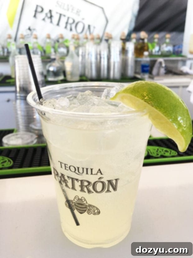 Guests enjoying Patron tequila at a lively booth during the festival