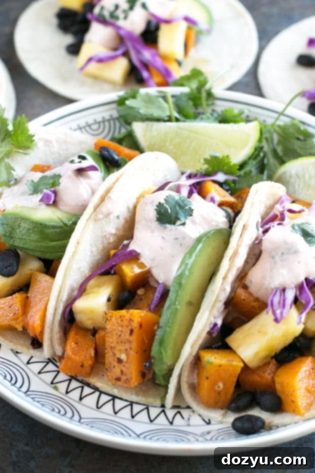 Close-up shot of a Roasted Butternut Squash Black Bean Taco, showing the filling and toppings. #vegetarian #healthy #tacotuesday #sponsored