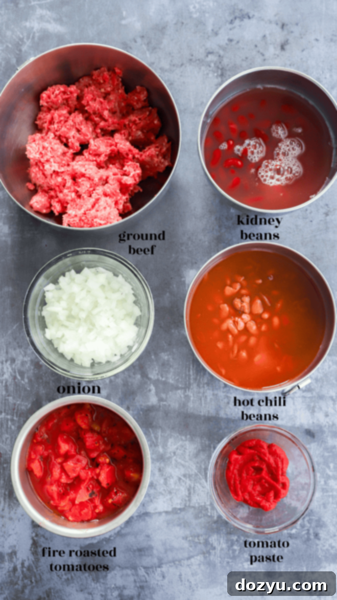 Bowls filled with the raw ingredients for spicy taco chili, clearly labeled for easy preparation.