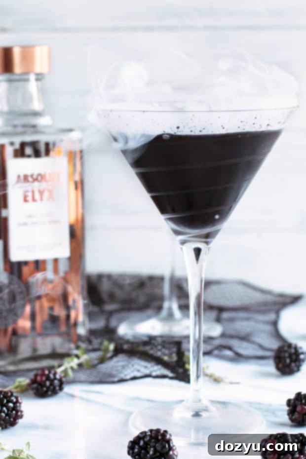 Absolut Elyx's Spellbinding Black Magic Martini 7 Absolut Elyx Black Magic Martini served in a copper coupe, highlighting its dark liquid and elegant presentation.