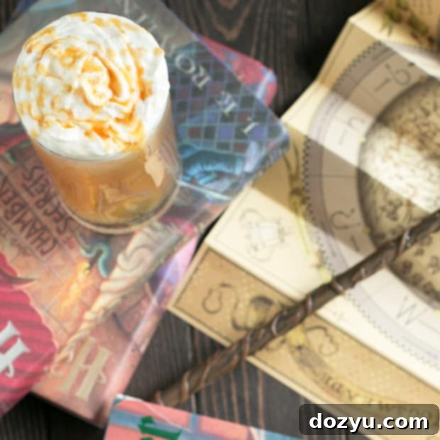 A delicious Butterbeer Cocktail topped with whipped cream and butterscotch, featured in a recipe card format.
