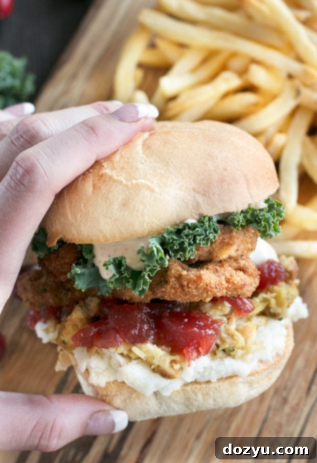 An overhead view of a Thanksgiving leftover sandwich featuring perfectly fried turkey, greens, and sauce, ready to be enjoyed.