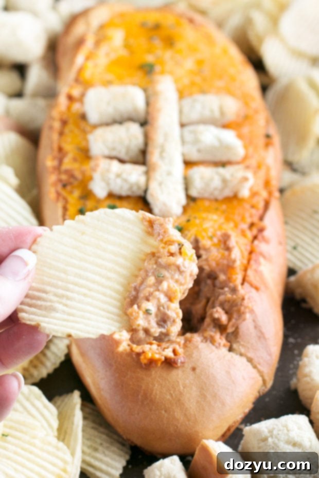 Savory Cheesy Pulled Pork BBQ Bread Dip shaped like a football, perfect for tailgating and game day celebrations.