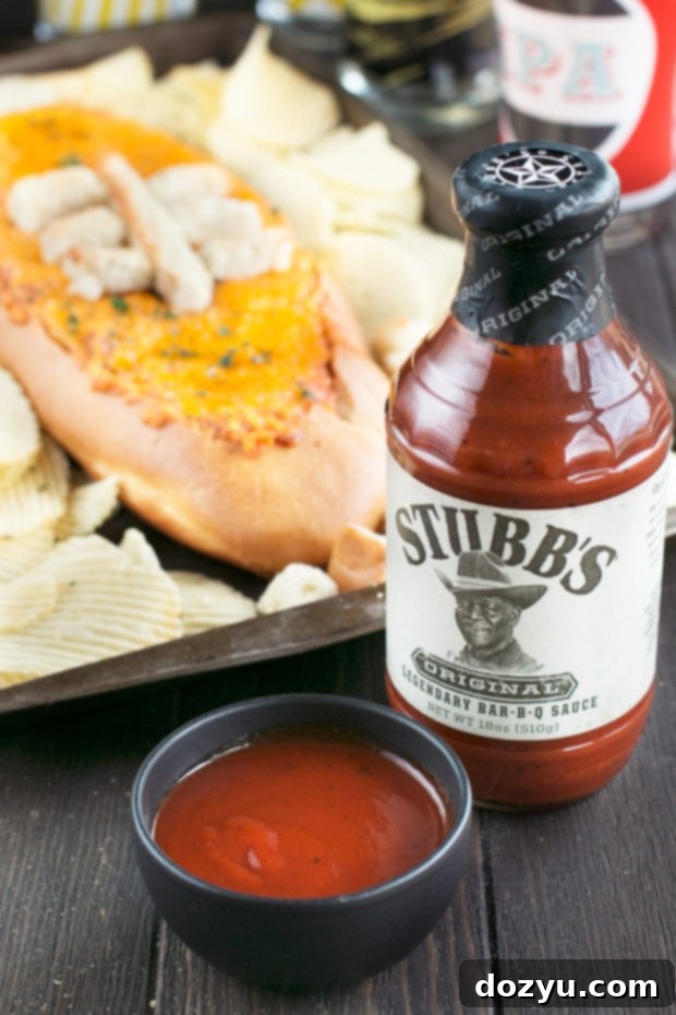 Serving Cheesy Pulled Pork BBQ Bread Dip with toasted bread cubes and chips for easy dipping.