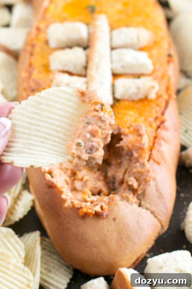 Cheesy Pulled Pork BBQ Bread Dip served with a variety of dippers for a party.