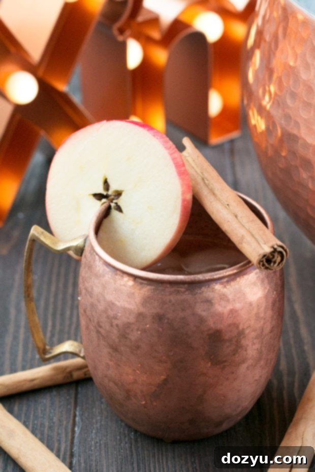 Styled image of Gingerbread Bourbon Punch with various holiday props and decor, emphasizing festive entertaining.