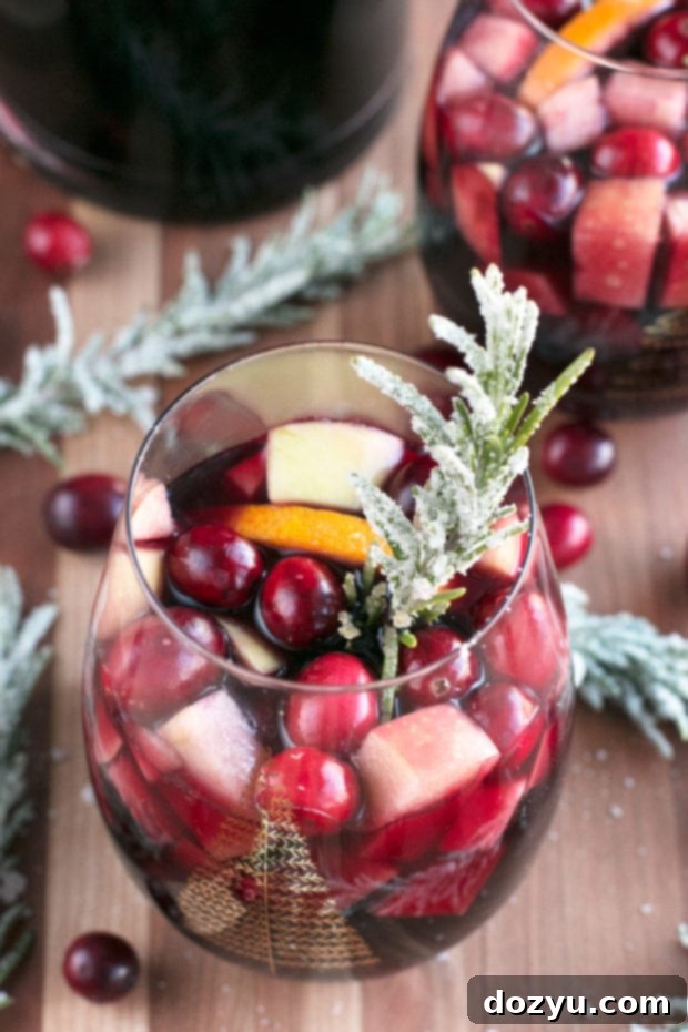 Red Christmas Single Serve Sangria with frosted rosemary garnish