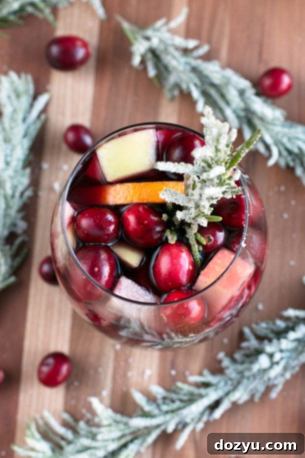 Close-up of Red Christmas Single Serve Sangria with frosted rosemary