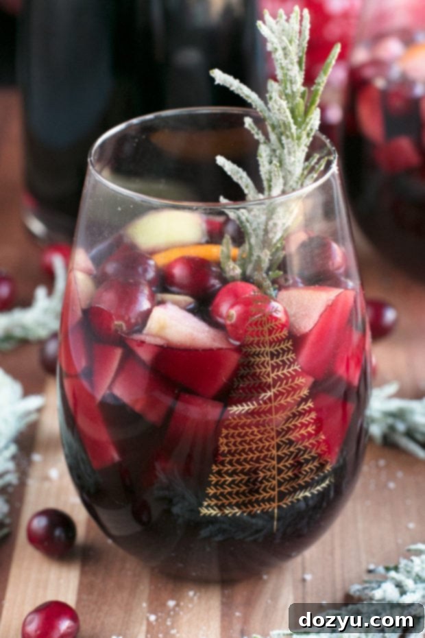 Single serve red Christmas sangria with a side of festive snacks