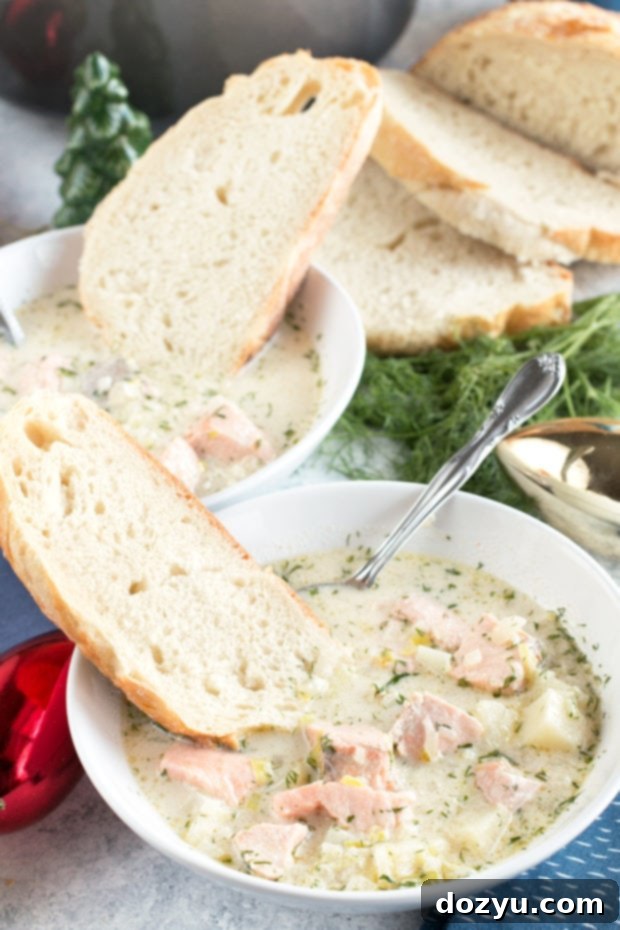 A bowl of hot Salmon Chowder with a spoon, highlighting its creamy texture