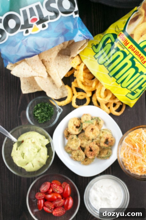 Triple Layer Chipotle Chicken Queso Nachos with Fried Jalapeños