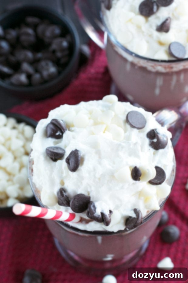 Garnished Boozy Zebra Hot Chocolate in a clear mug, close-up