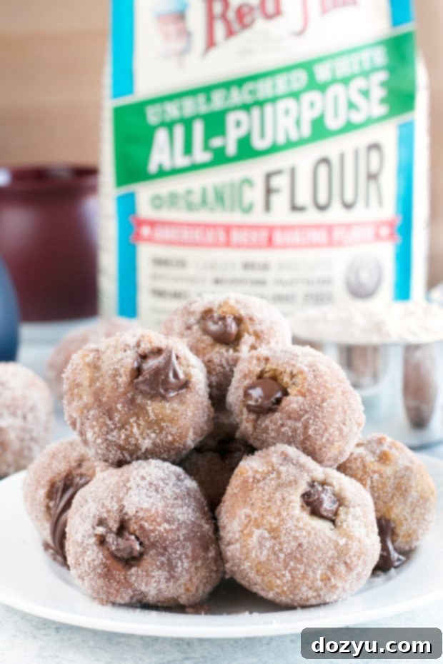 Pile of Golden Nutella Donut Holes on a Cooling Rack