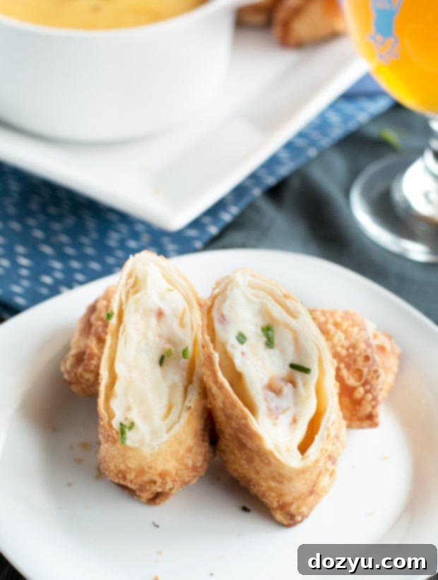 Crispy Loaded Mashed Potato Egg Rolls 6 Hands dipping a Loaded Mashed Potato Egg Roll into Beer Cheddar Sauce
