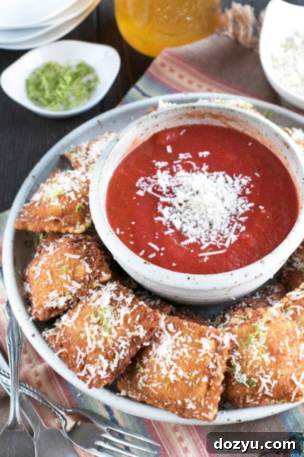 Golden brown Berbere Fried Ravioli served with marinara sauce, perfect for a spicy appetizer