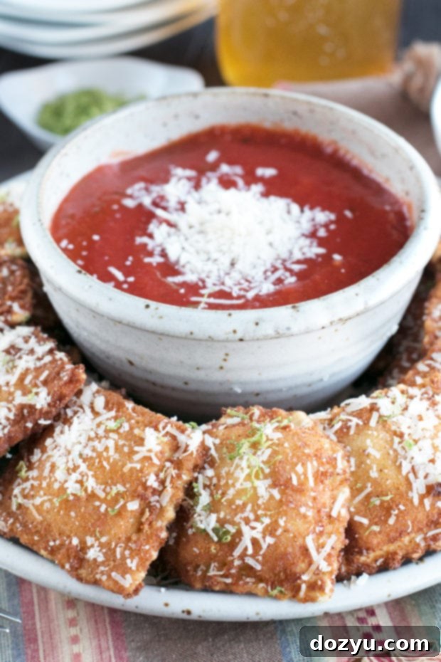 Berbere Fried Ravioli on a wire rack to drain excess oil, ensuring maximum crispiness