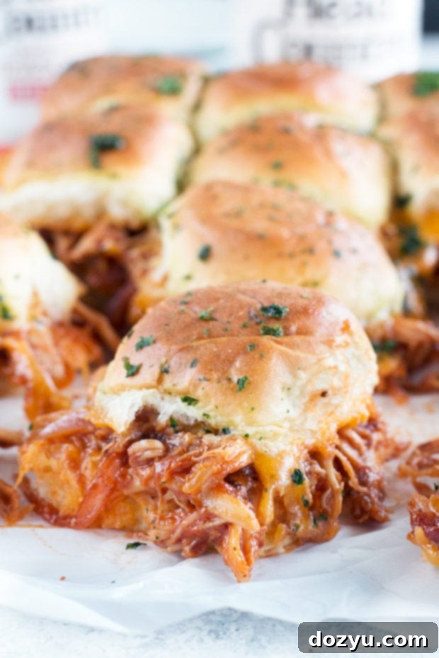 Close-up of baked Cheesy BBQ Chicken Pull Apart Sliders showing melted cheese