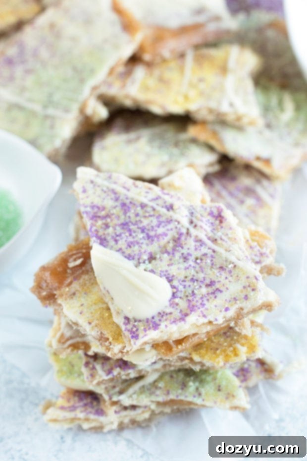Mardi Gras King Cake Brittle 2 A vibrant pile of King Cake Crack Candy, adorned with purple, green, and yellow decorative sugars, ready for Mardi Gras celebrations.