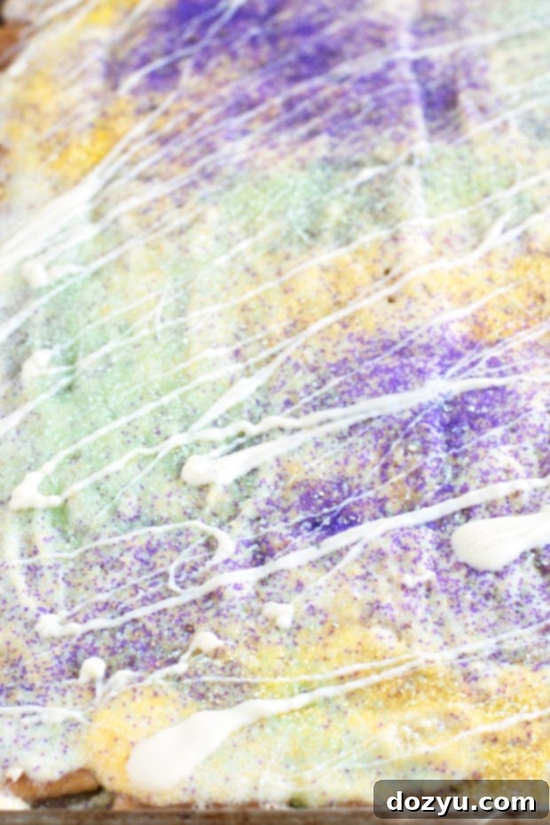 Mardi Gras King Cake Brittle 3 A sheet pan filled with King Cake Crack Candy, showcasing the golden caramel and colorful sprinkles before being broken into pieces.