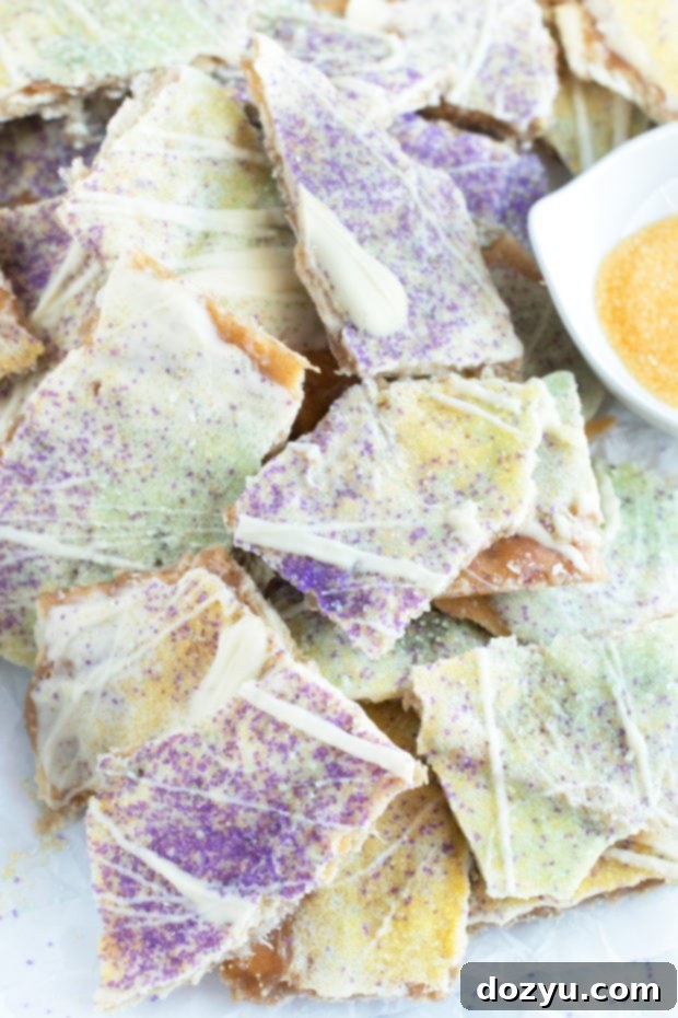 Mardi Gras King Cake Brittle 4 A close-up shot of individual pieces of King Cake Crack Candy, highlighting the texture and colorful sugar toppings.