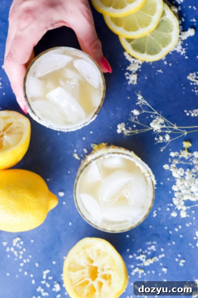 Overhead image of lemon cocktails with hand
