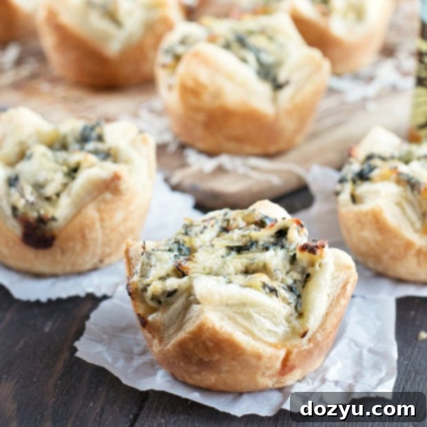 A vibrant Chicken Spinach Artichoke Dip Puff, showcasing its golden crust and creamy filling, a perfect appetizer.