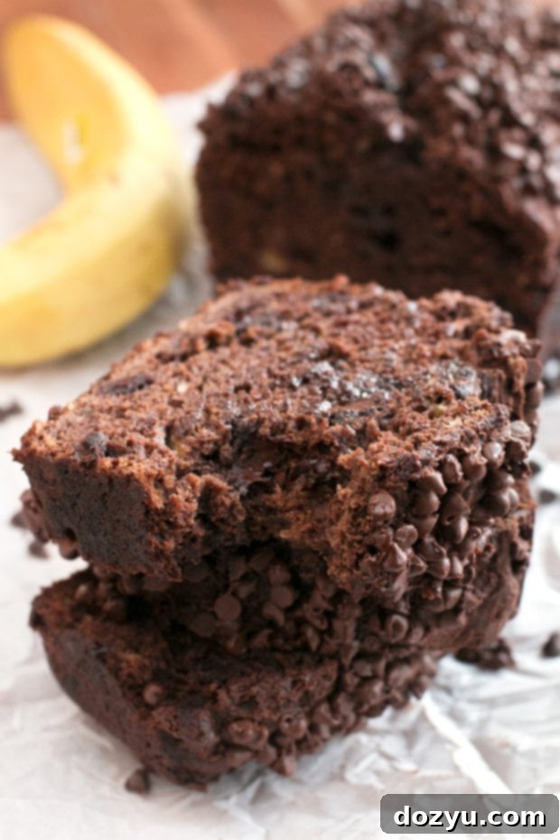 Close-up of a slice of Double Chocolate Avocado Banana Bread, showcasing avocado's rich green color and dark chocolate