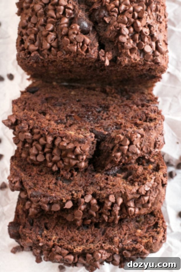 A whole loaf of Double Chocolate Avocado Banana Bread on a wooden board