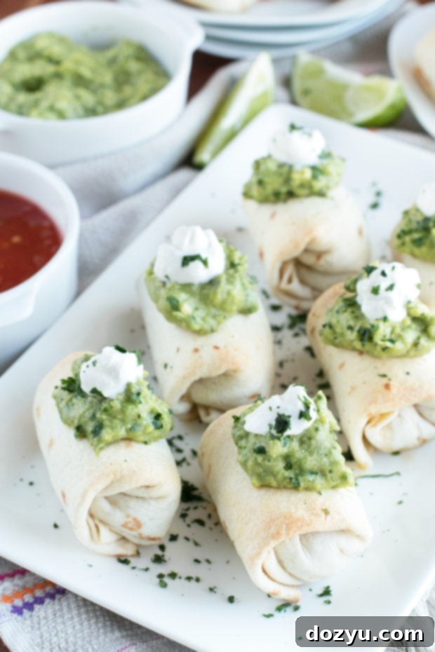 A plate of perfectly Baked Mini Chimichangas with a generous dollop of creamy spicy guacamole