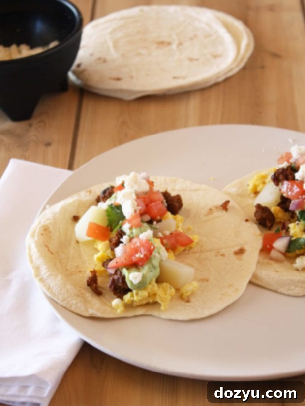 Homemade Breakfast Tacos with vibrant avocado crema on a plate