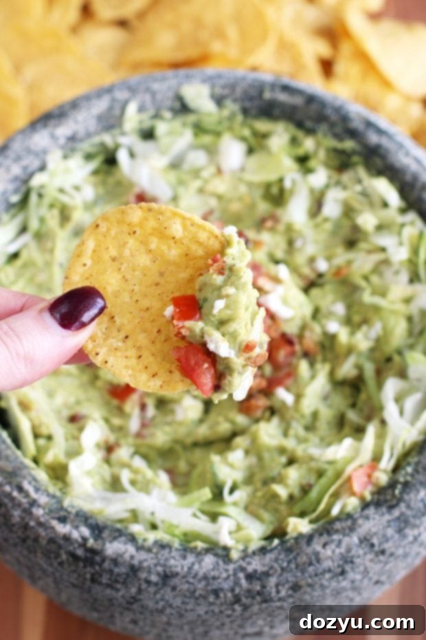 BLT Guacamole served in a traditional molcajete, showcasing its vibrant colors and textures.