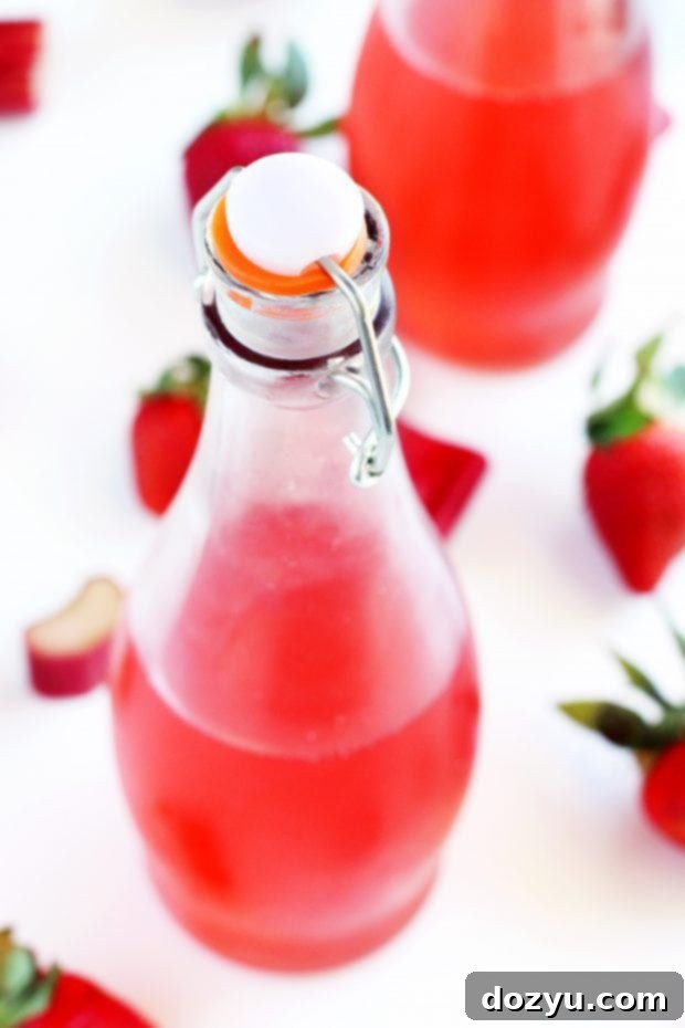 Jar of Homemade Strawberry Rhubarb Simple Syrup ready for use