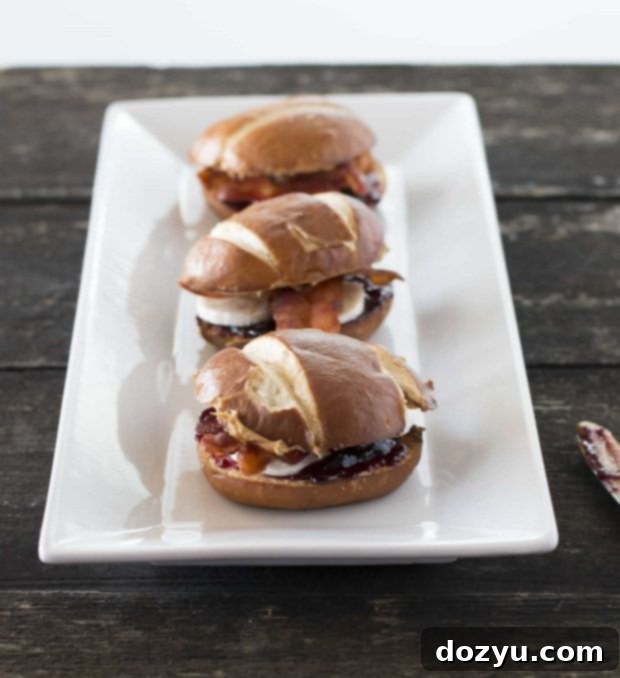 The King's Sliders 2 Delicious Elvis Sliders on toasted pretzel buns, ready to be enjoyed.