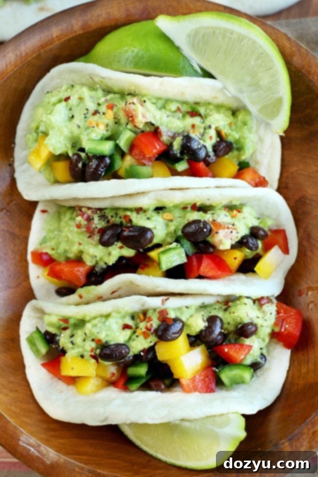 A selection of fresh ingredients like avocado, bell peppers, and cilantro for guacamole tacos